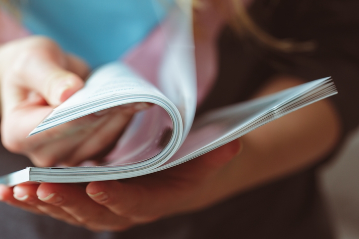 Woman flicking through a magazine